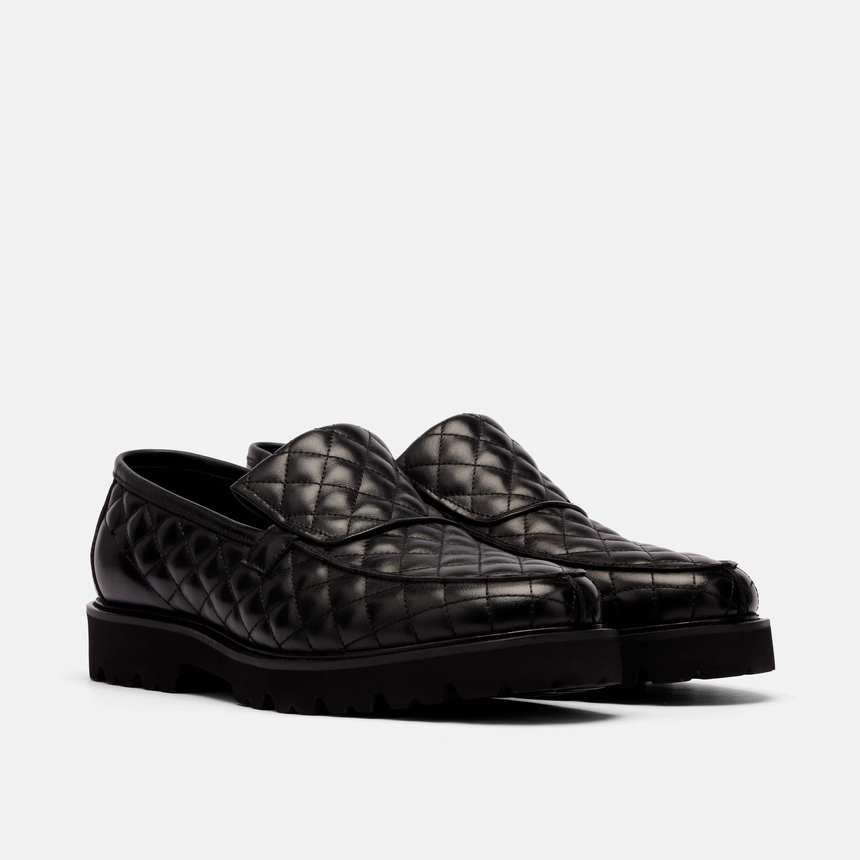 The Pitch Black Quilted Leather Lug Penny Loafers